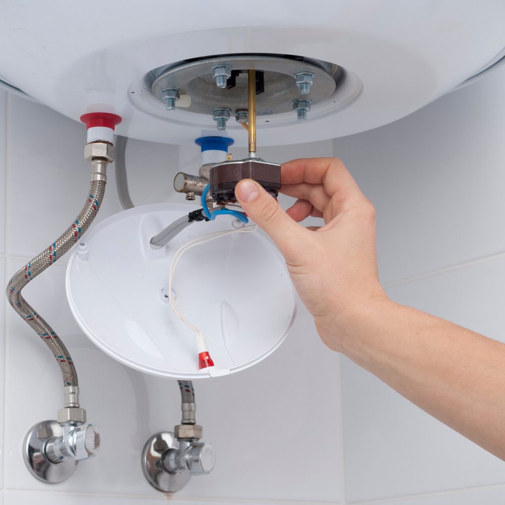 Master,Holds,A,Thermostat,From,An,Electric,Boiler,In,His